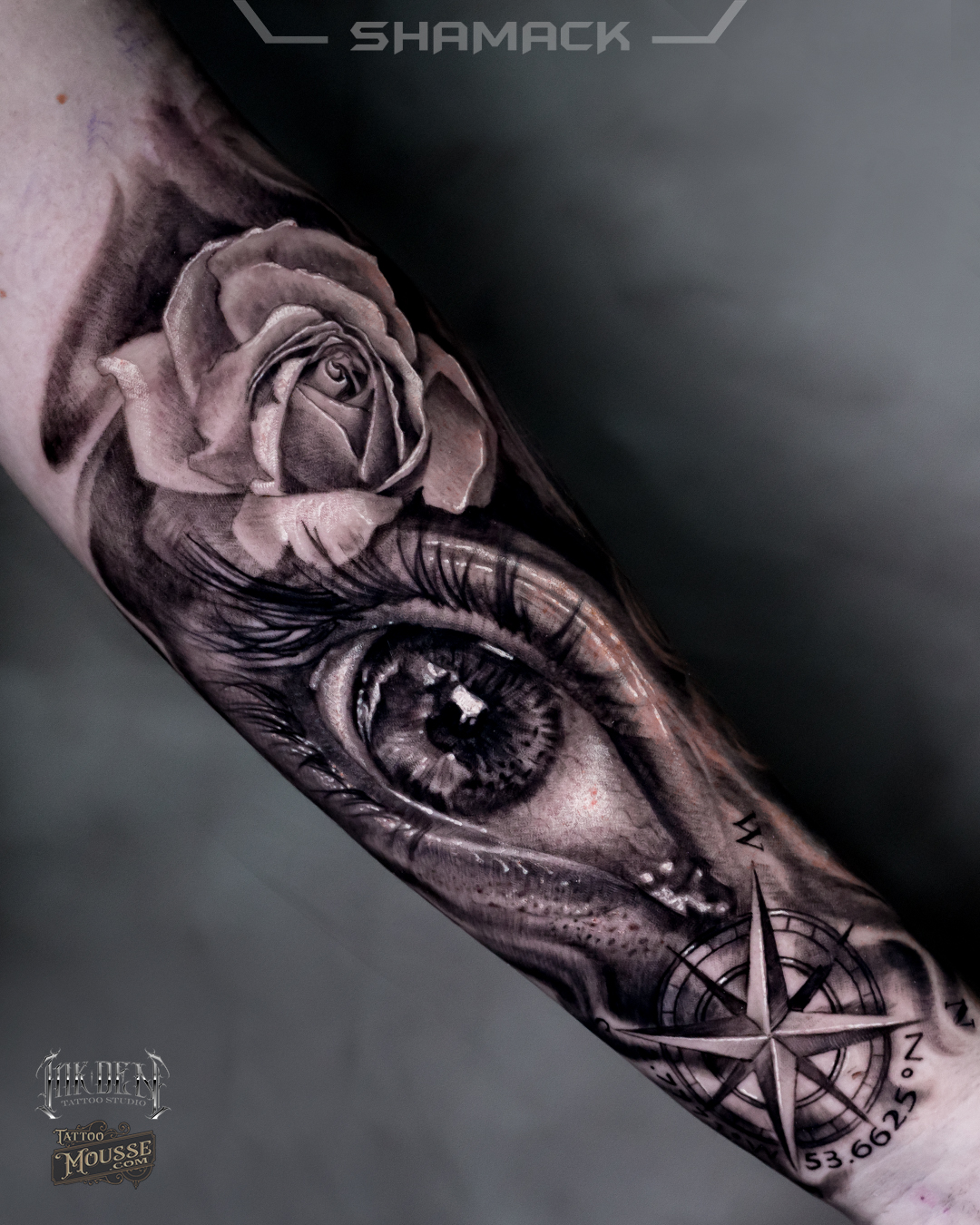 Black and grey compass tattoo located on the forearm