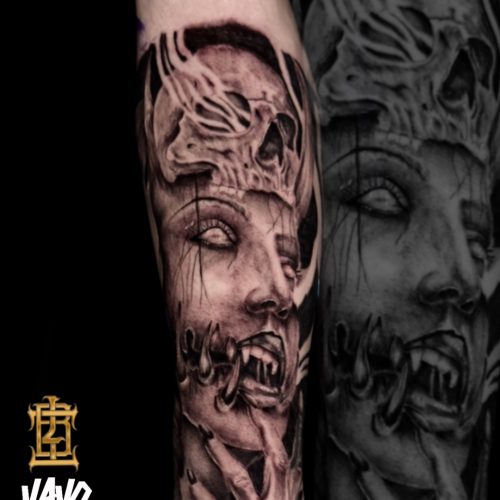 demon-vibes-femaledemon-skull-piercedteeth-blackandgrey-lowerarm-Luke-Tattoo-Inkden-Blackpool